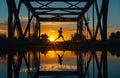 Silhouette Runner on Bridge at Sunset with Water Reflection Royalty Free Stock Photo