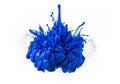 Dynamic splash of blue paint captured mid-air against a white background. The paint forms a Royalty Free Stock Photo