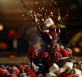 A dynamic splash of chocolate over fresh berries and marshmallows, capturing the essence of indulgence. Royalty Free Stock Photo