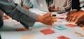 Team Collaboration Session with Sticky Notes on Table and Laptop in Modern Office Setting, Focus on Hands Engaging in Royalty Free Stock Photo