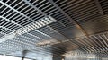 Dynamic Texture The interlocking metal bars of the grating create a dynamic texture on the ceiling adding visual Royalty Free Stock Photo
