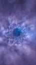 Dynamic tunnel of shimmering dots in blue and violet tones, resembling a digital wormhole Royalty Free Stock Photo