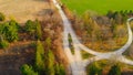 Dynamic video of countryside in north america at fall. Aerial view of unusual road between trees and farm fields in fall