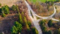 Dynamic video of countryside in north america at fall. Aerial view of unusual road between trees and farm fields in fall