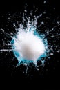 Dynamic water splash against a black background with a white object in motion Royalty Free Stock Photo