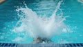 Dynamic water splash from swimmer making sharp turn in clear pool water. Motion blur captures athlete speed, power during Royalty Free Stock Photo