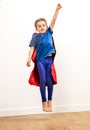 Dynamic young kid reaching high like a powerful superhero, flying