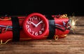 Dynamite time bomb on wooden table against black background, closeup Royalty Free Stock Photo