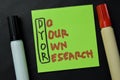 DYOR - Do your Own Research write on sticky notes isolated on office desk