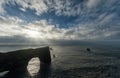 Dyrholaey Area in Iceland. Close to Black Sand Beach. Sunrise. Sunlight. Rocks in Water. Royalty Free Stock Photo