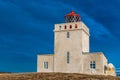 The Dyrholaey lighthouse in Iceland stands guard in stormy skies