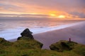 Amazing landscape with basalt rock formations Troll toes (Trolls fingers) on Black Beach. Ocean waves flow around stones. Midnight Royalty Free Stock Photo