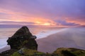 Amazing landscape with basalt rock formations Troll toes (Trolls fingers) on Black Beach. Ocean waves flow around stones. Midnight Royalty Free Stock Photo