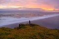 Amazing landscape with basalt rock formations Troll toes (Trolls fingers) on Black Beach. Ocean waves flow around stones. Midnight Royalty Free Stock Photo