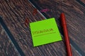 Dyscalculia write on a sticky note Isolated on wooden table background