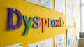 Dyspraxia brightly displayed on bulletin board with kids\' artwork for learning and therapy success Royalty Free Stock Photo