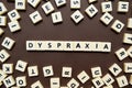 Dyspraxia letters brown background Royalty Free Stock Photo