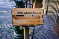 A bike with wooden basket saying 'Wein schenkt Freude' / 'Wine gives pleasure' seen in a beautiful old alley.