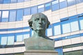 Closeup of stone sculpture of painter Wilhelm von Schadow, modern building background