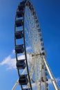 Low angle view on isolated ferries wheel against blue sky