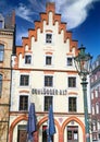 View on historic old building with gabled roof against blue sky, logo of local traditional SchlÃÂ¶sser Alt brewery Royalty Free Stock Photo