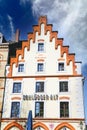 View on historic old building with gabled roof against blue sky, logo of local traditional SchlÃÂ¶sser Alt brewery