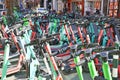 View on many countless green Tier e-scooters wildly jumbled parked in city center