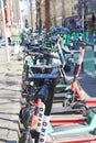 View on many green e-scooters parked in a row in city center