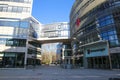 View over square on modern arch between two buildings to city park