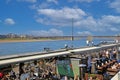 View on outside restaurant cafe with sitting people on sunny winter day, river Rhine and Oberkasseler bridge background