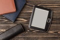 E-book reader close-up on wooden background Royalty Free Stock Photo