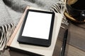 E-book reader with notebook and coffee on wooden table, closeup. Space for text Royalty Free Stock Photo