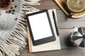 E-book reader with notebook and coffee on wooden table, flat lay. Space for text Royalty Free Stock Photo