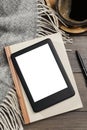 E-book reader with notebook and coffee on wooden table, flat lay. Space for text Royalty Free Stock Photo