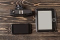 E-book reader, smartphone close-up on wooden background Royalty Free Stock Photo