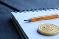 E-Business concept, gold coin and pencil with the inscription Royalty Free Stock Photo