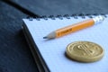 E-Business concept, gold coin and pencil with the inscription Royalty Free Stock Photo