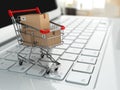 E-commerce. Shopping cart with cardboard boxes on laptop. Royalty Free Stock Photo