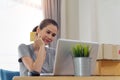 Asian beautiful girl buying online from website using credit card for payment. Royalty Free Stock Photo