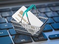 E-commerce, shopping online and internet purchases concept. Shopping basket with credit card on laptop keyboard