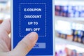 E-coupon, Grocery shopping online, Hand using mobile phone with discount coupon on screen, online shopping sale on smartphone,