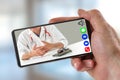 E-health: hand of a man holding Smartphone, mobile phone with calling icon in here,phone ,song,camera,and messaging,and Royalty Free Stock Photo