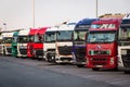 E30 HIGHWAY, GERMANY - JUN 14, 2019: Row of various company trucks parked at a truck overnight parking somwehere along the E30