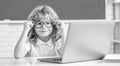 e-learning. child studying on computer. smiling teen boy in classroom. back to school. Royalty Free Stock Photo