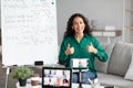 Female teacher showing thumbs up gesture, explaining math to students Royalty Free Stock Photo