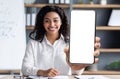 E-Learning Concept. Smiling Black Female Tutor Showing Big Blank Smartphone At Camera