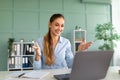 E-learning. Positive female teacher having video conference call using laptop, talking to webcam Royalty Free Stock Photo