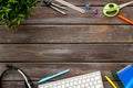 E-learning. Stationery, headphones and keyboard on wooden table top-down frame copy space