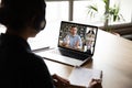 Pc screen view over woman shoulder during group videocall elearning Royalty Free Stock Photo