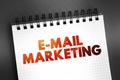 E-mail Marketing - act of sending a commercial message to a group of people, using email, text on notepad, concept background